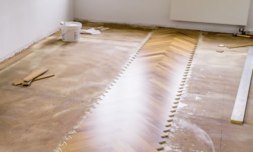 View of floor in the process of having parquet flooring layed
